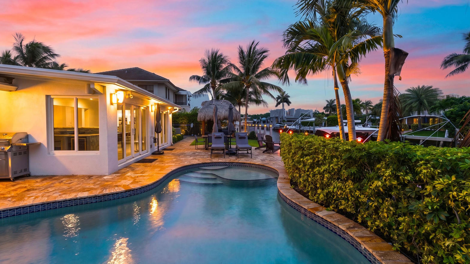Waterfront pool home at sunset
